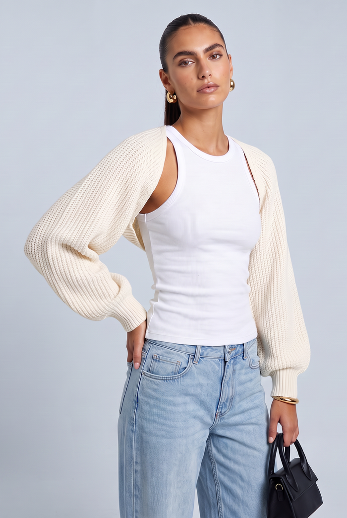 Kovelle cropped knit bolero in white, three-quarter view on model