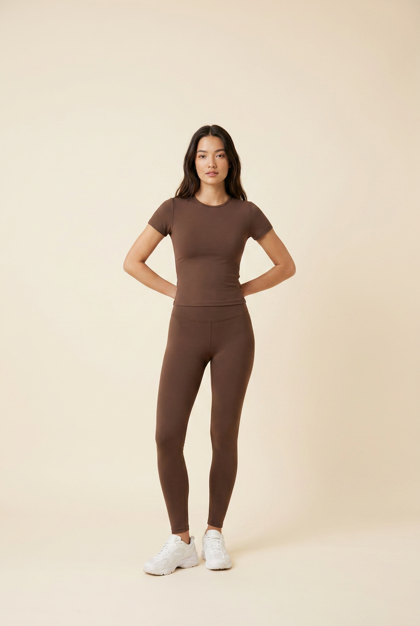 Kovelle round neck legging set in coffee, hands on the back of her hips, on model