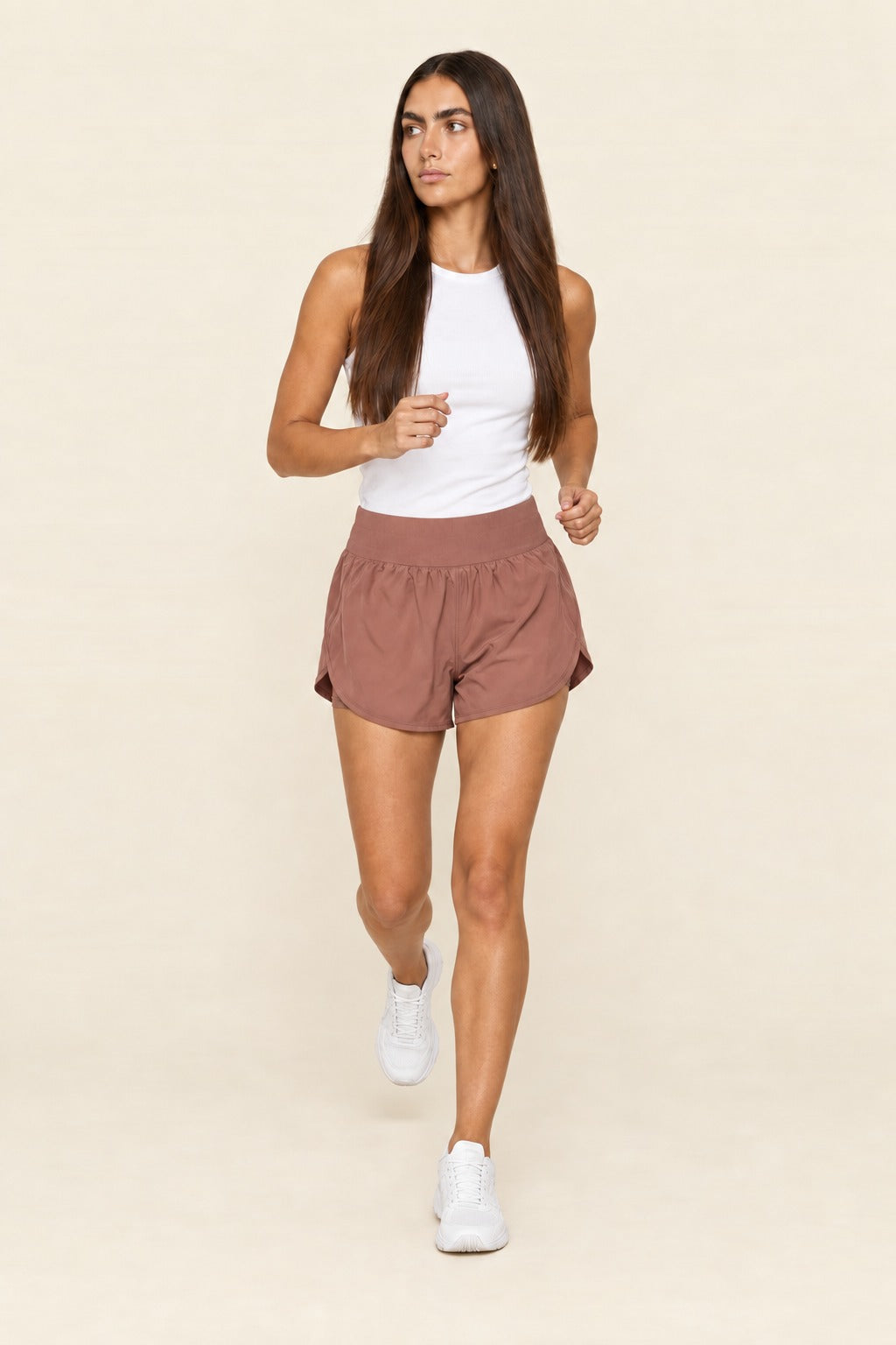 Kovelle relaxed yoga shorts in rose brown, mid jog toward the camera, on model