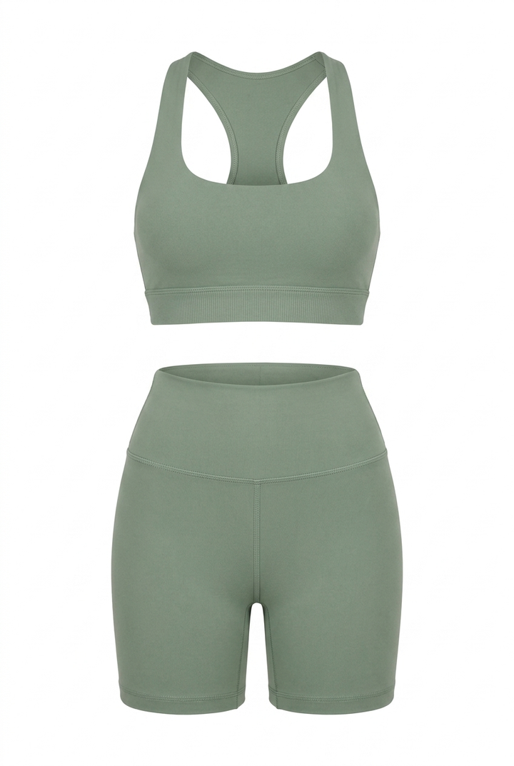 The Kovelle Seamless Halter Gym Set in sage photographed on its own against a white background, showing the halter bra and matching shorts