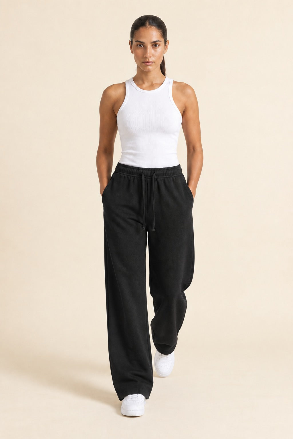 Kovelle wide leg joggers in black, walking mid stride, on model