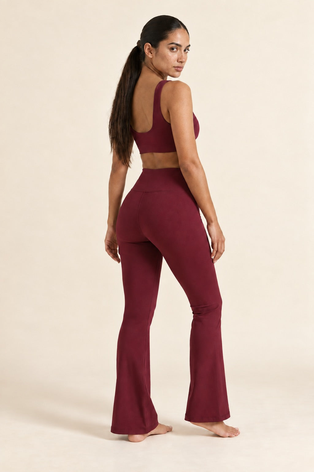 Kovelle high waist flare leggings in wine red, over the shoulder, on model