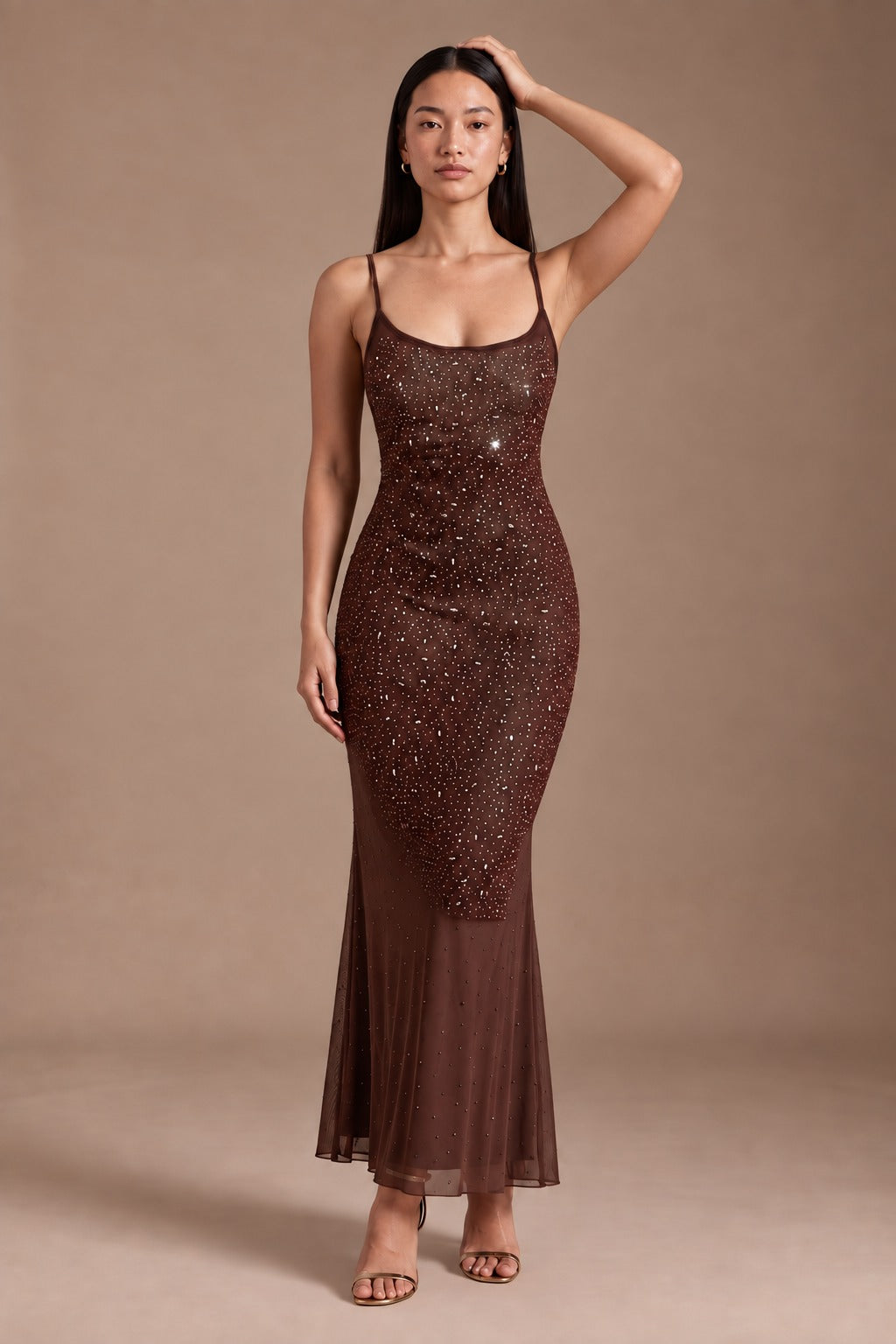 Model posing in the chocolate beaded mesh slip maxi dress