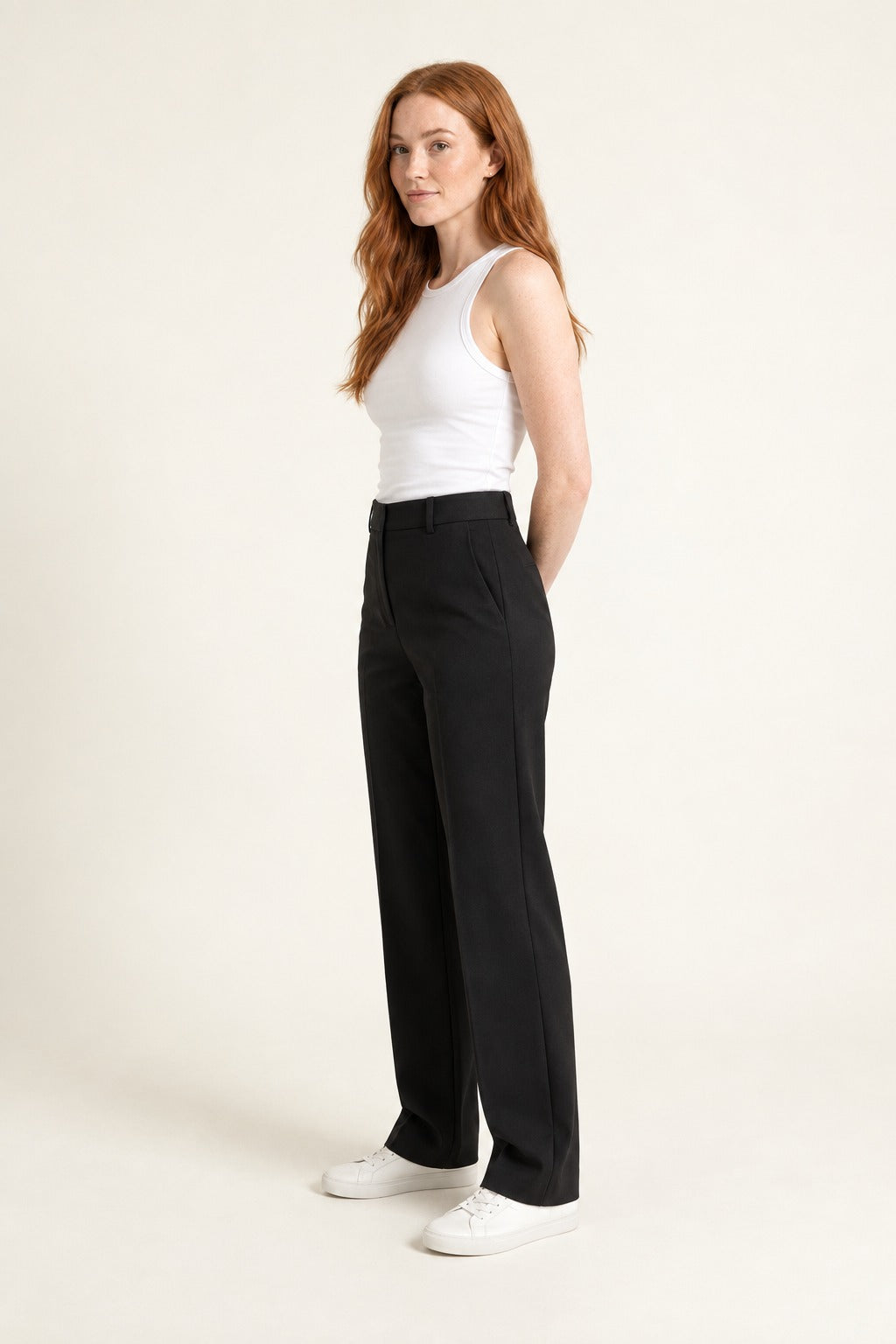 Kovelle tailored high-waist straight-leg trousers in black, three-quarter view on model