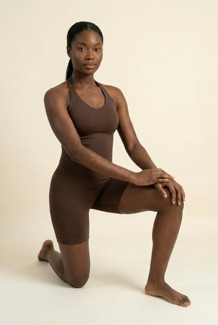 Kovelle halter vest gym set in chocolate, vest and fitted shorts, kneeling pose, on model