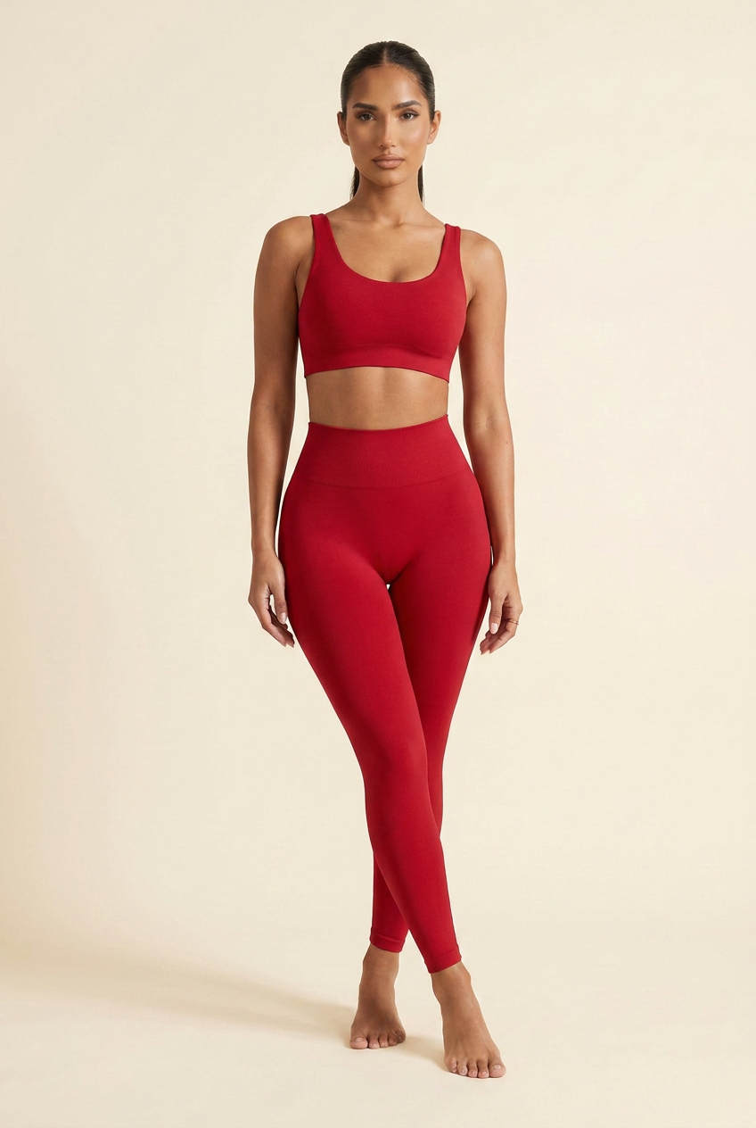 Kovelle sculpt seamless leggings in red, standing with legs crossed, on model
