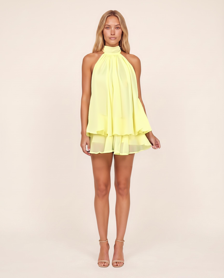 Kovelle Butter Chiffon Halter Mini Dress in butter yellow, high halter neck and swing shape, front view, on model