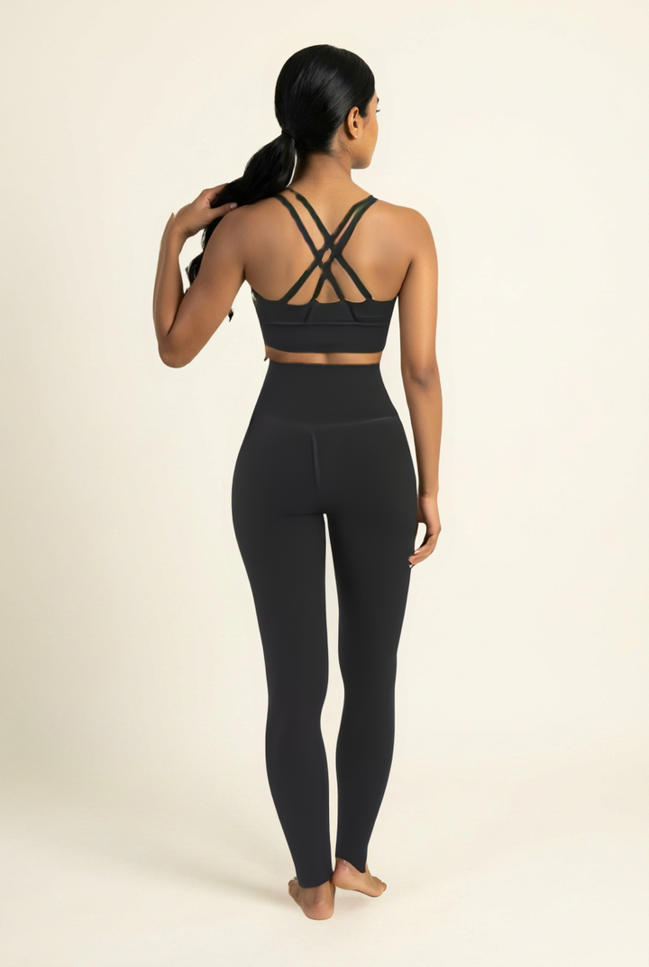 Kovelle cross back leggings set in black, back view showing crossed straps, on model