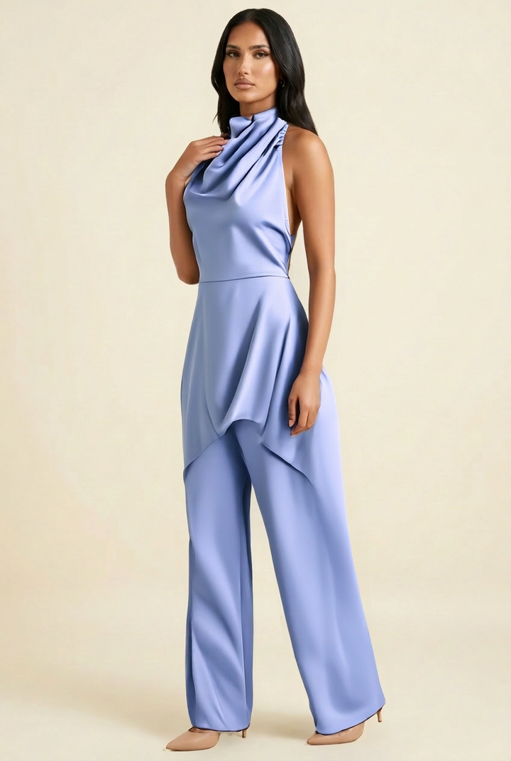 Kovelle satin cowl halter trouser co-ord in blue, side view showing waterfall hem on model