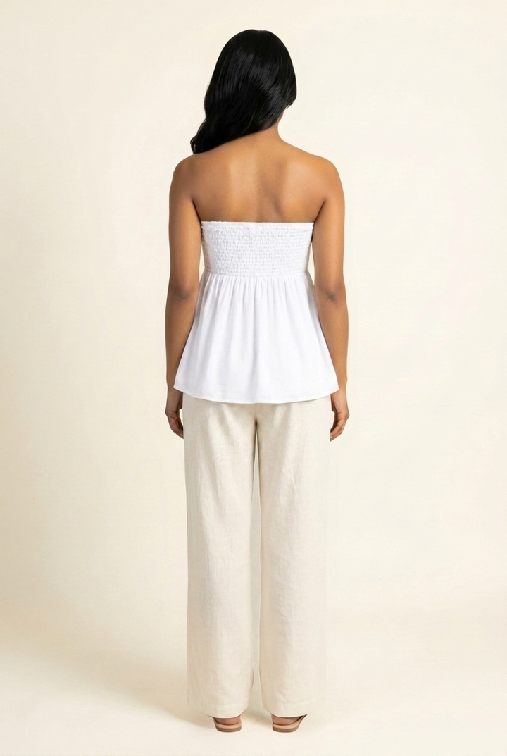 Kovelle shirred bandeau babydoll top in white, smocked back view on model