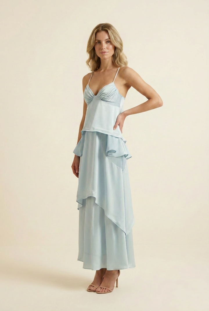Kovelle tiered ruffle halter maxi dress in baby blue, three quarter angle, hand on hip, on model