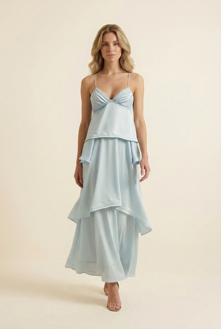 Kovelle tiered ruffle halter maxi dress in baby blue, walking shot with skirt tiers in motion, on model