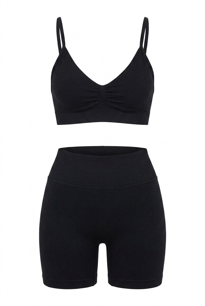 The Kovelle Ruched Seamless Gym Set in black photographed on its own against a white background, showing the ruched bra and matching shorts