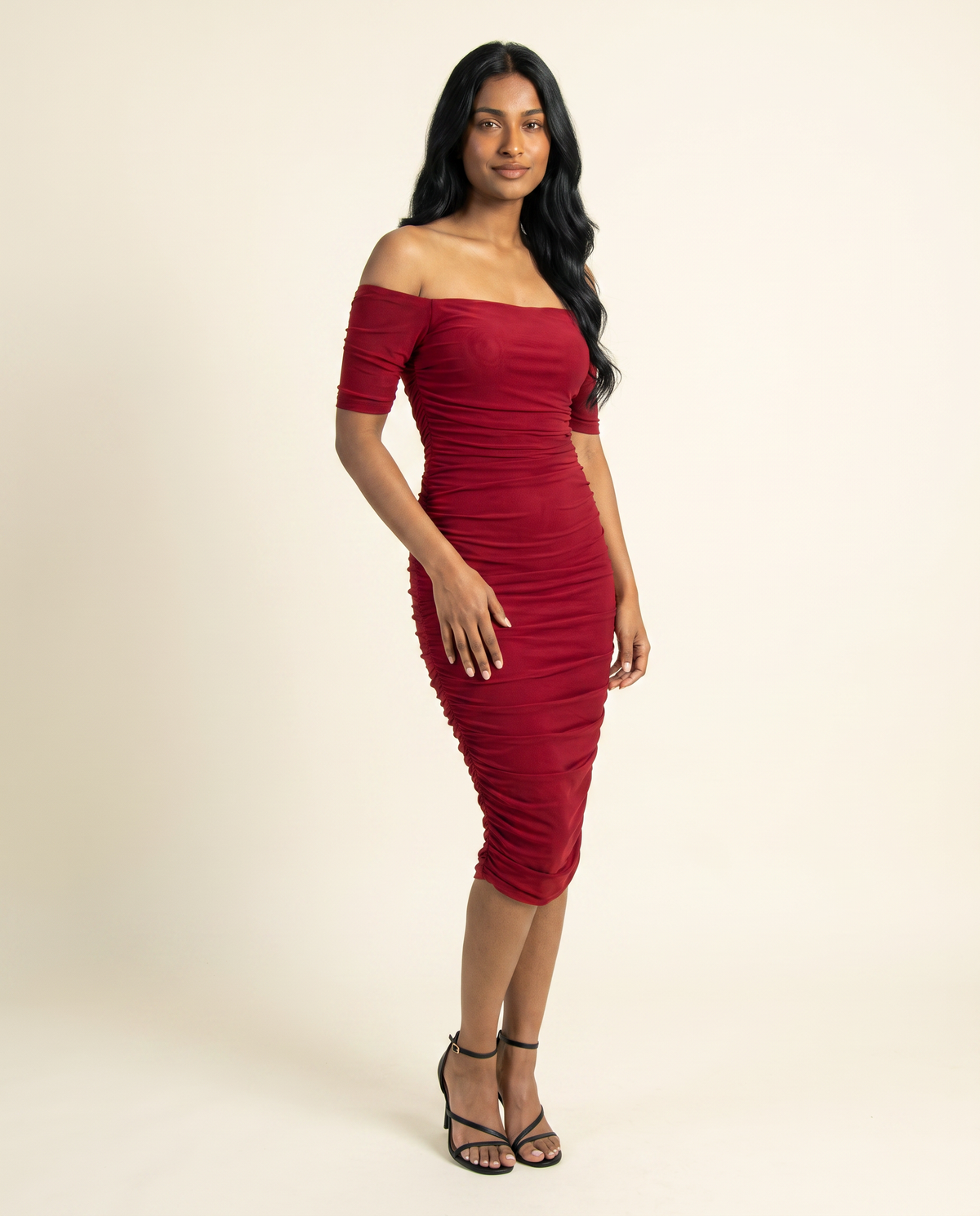 Kovelle red ruched midi dress three quarter view, on model