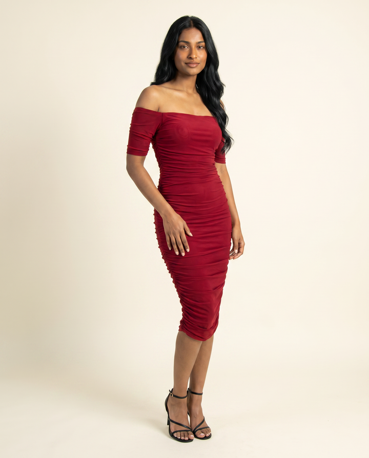 Kovelle red ruched midi dress three quarter view, on model