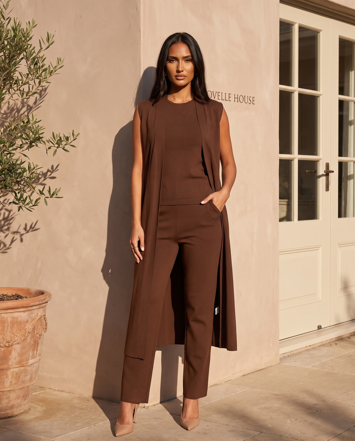 Kovelle chocolate three piece waistcoat and trouser set, on model at the Kovelle House courtyard