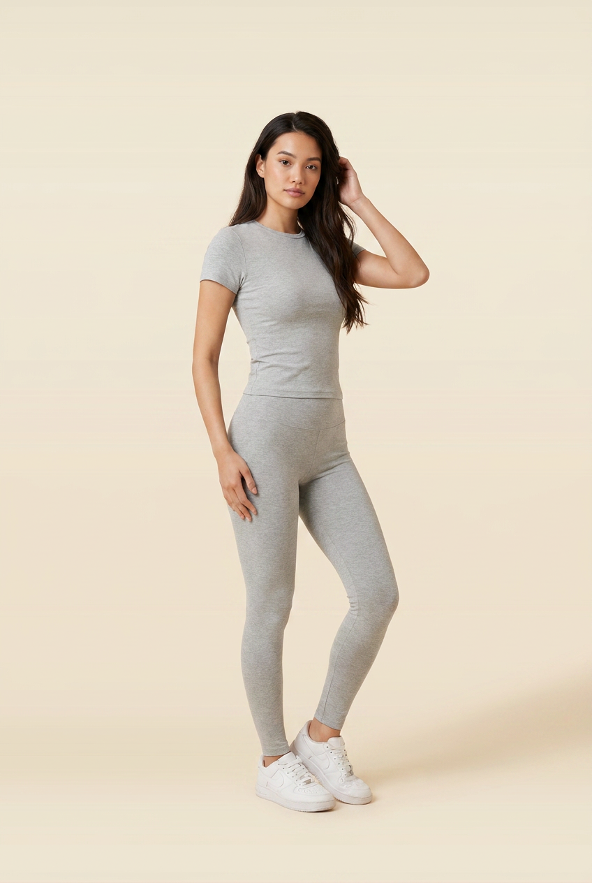 Kovelle round neck legging set in light grey, three quarter view with a hand in her hair, on model