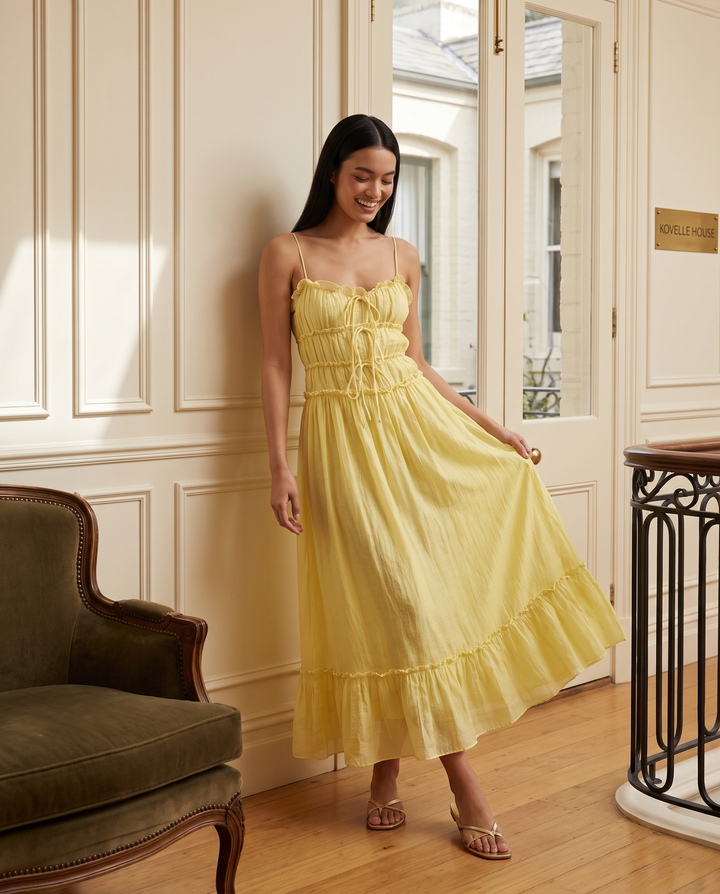 Kovelle yellow tiered frill maxi dress, on model in the Kovelle House salon