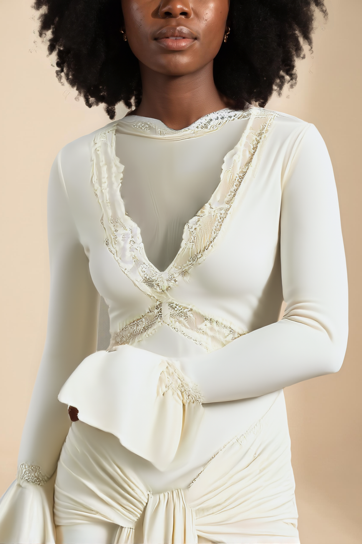 Close up of the lace edged V neckline and flared cuff on the ivory slinky lace maxi dress