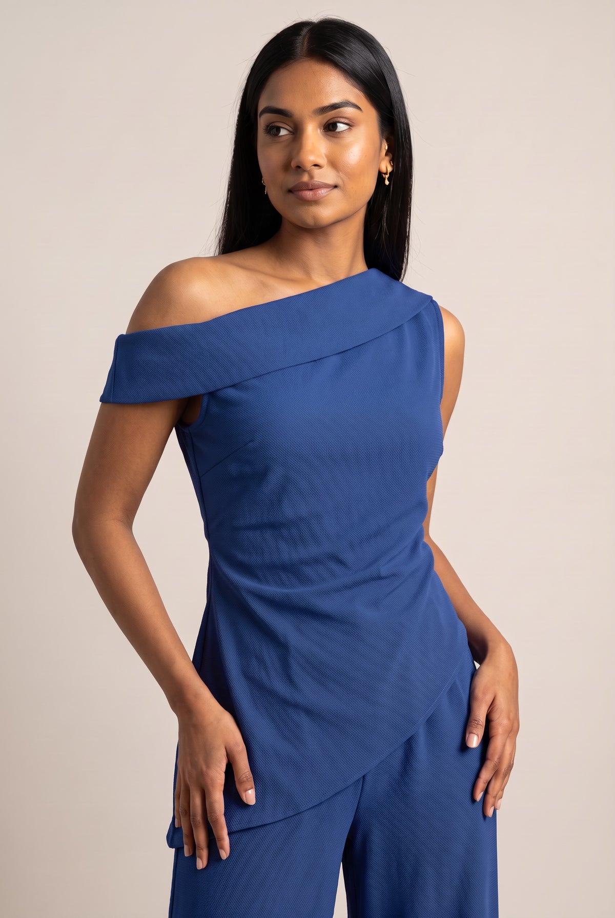 Kovelle asymmetric draped trouser set in cobalt, close-up detail on model