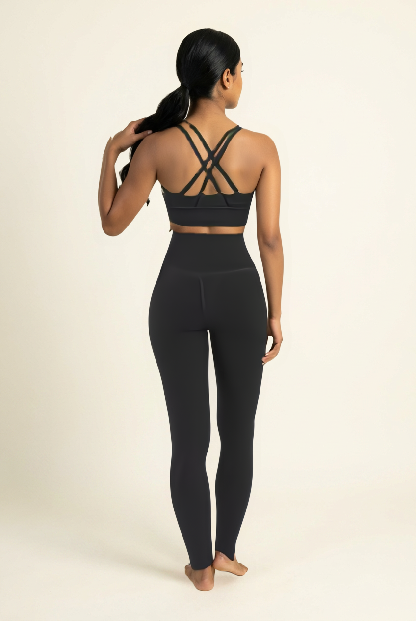 Kovelle cross back leggings set in black, back view showing crossed straps, on model
