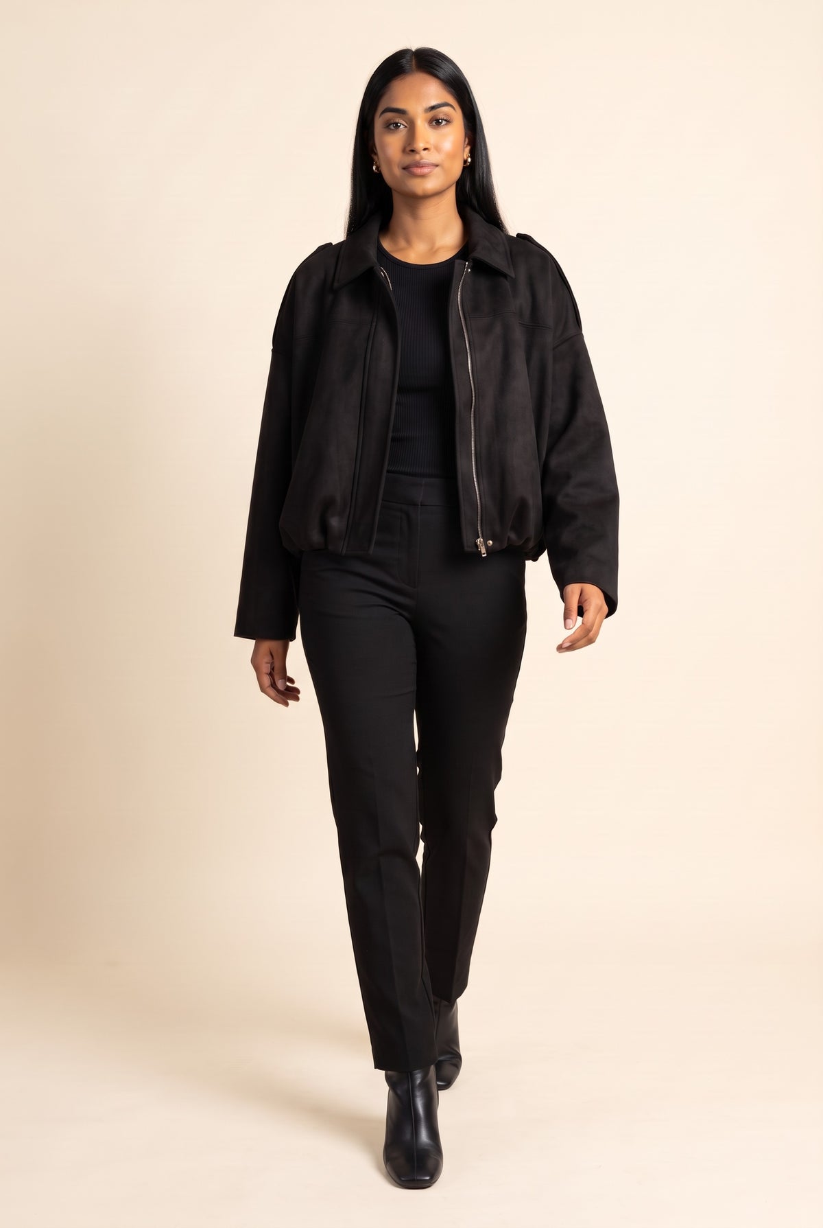 Kovelle faux suede bomber jacket in black, walking, full length on model