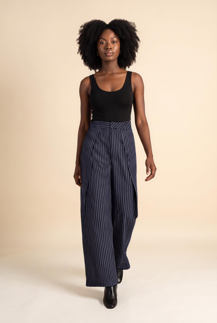 Kovelle pinstripe pleat-front trousers in navy pinstripe, walking, full length on model