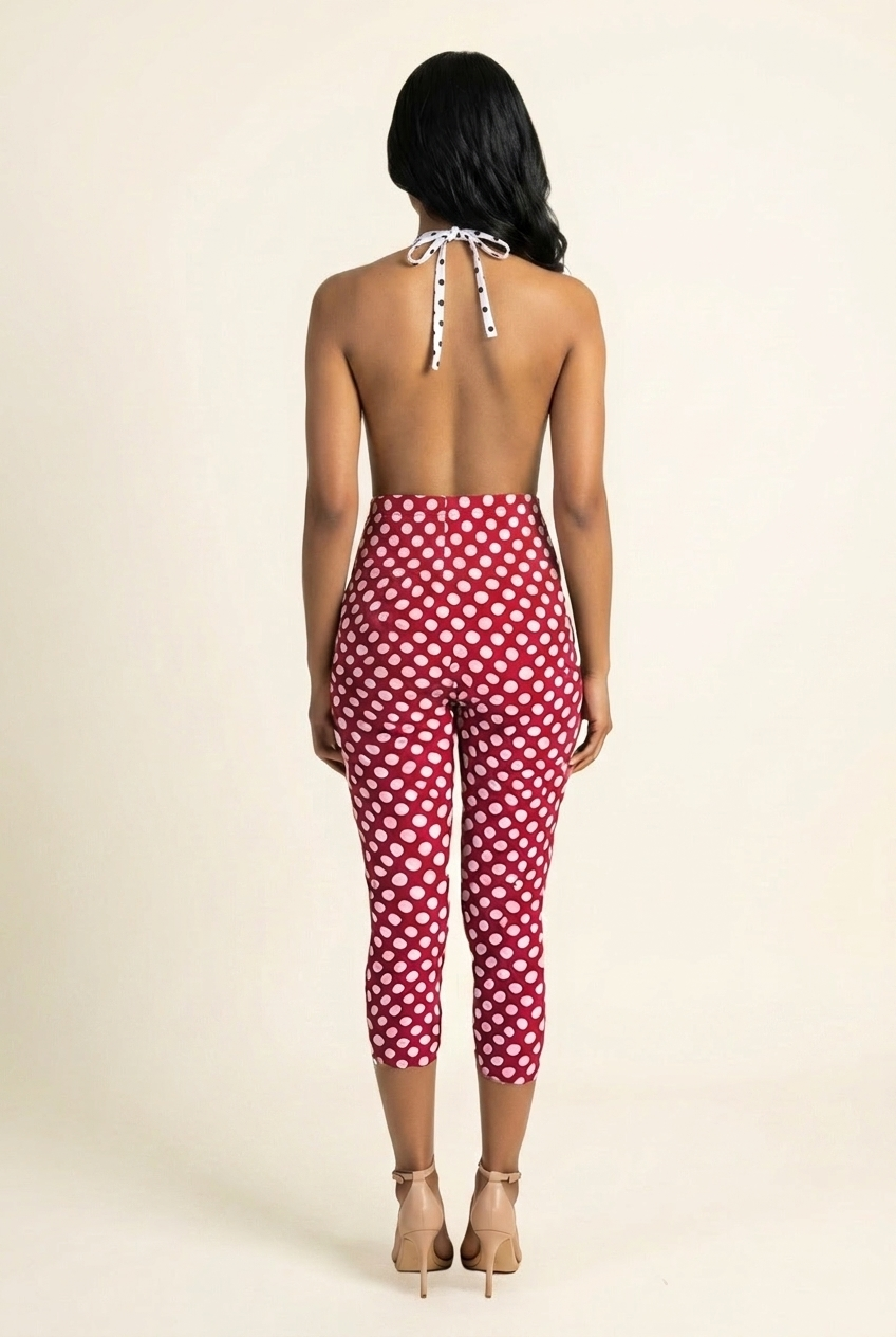 Kovelle polka dot halter capri jumpsuit in red, open backless back with halter tie on model