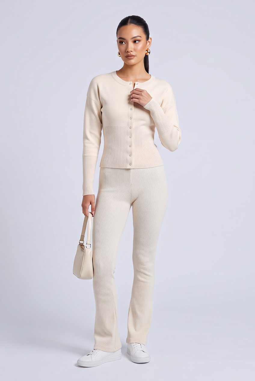 Kovelle rib snap button top in cream, full length on model