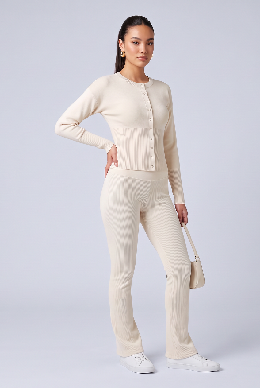 Kovelle rib snap button top in cream, three-quarter view on model