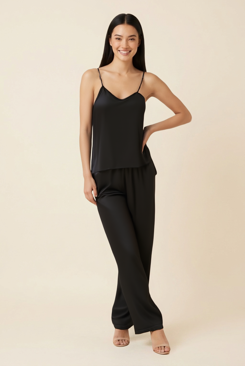 Kovelle satin cami trouser set in black, standing pose with hand on hip on model