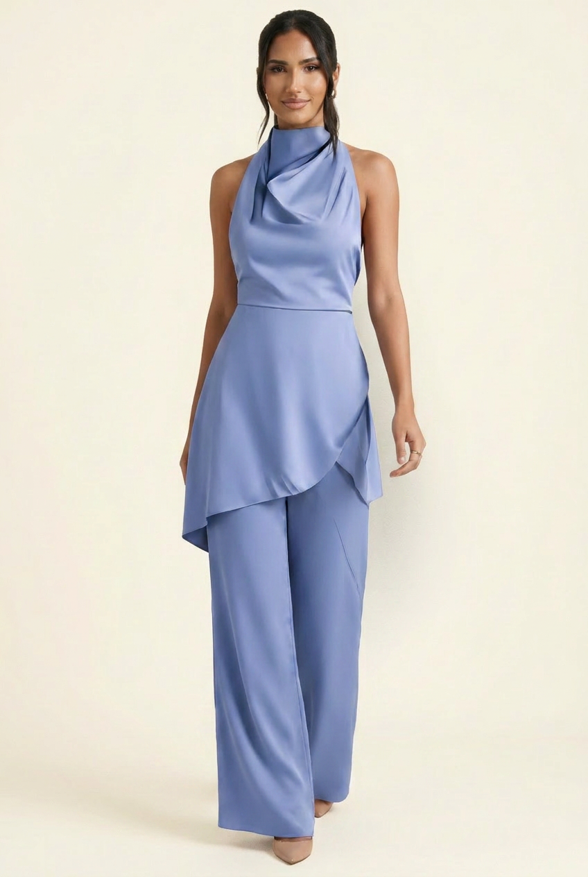 Kovelle satin cowl halter trouser co-ord in blue, walking shot with flowing trousers on model