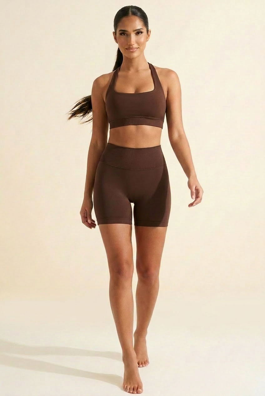 Kovelle seamless halter gym set in chocolate, walking shot, ribbed underband bra, on model
