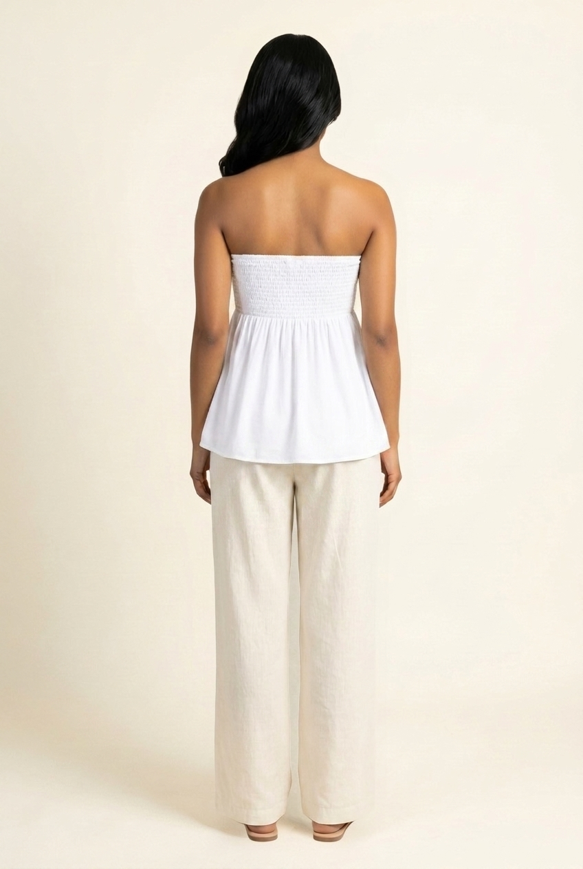 Kovelle shirred bandeau babydoll top in white, smocked back view on model