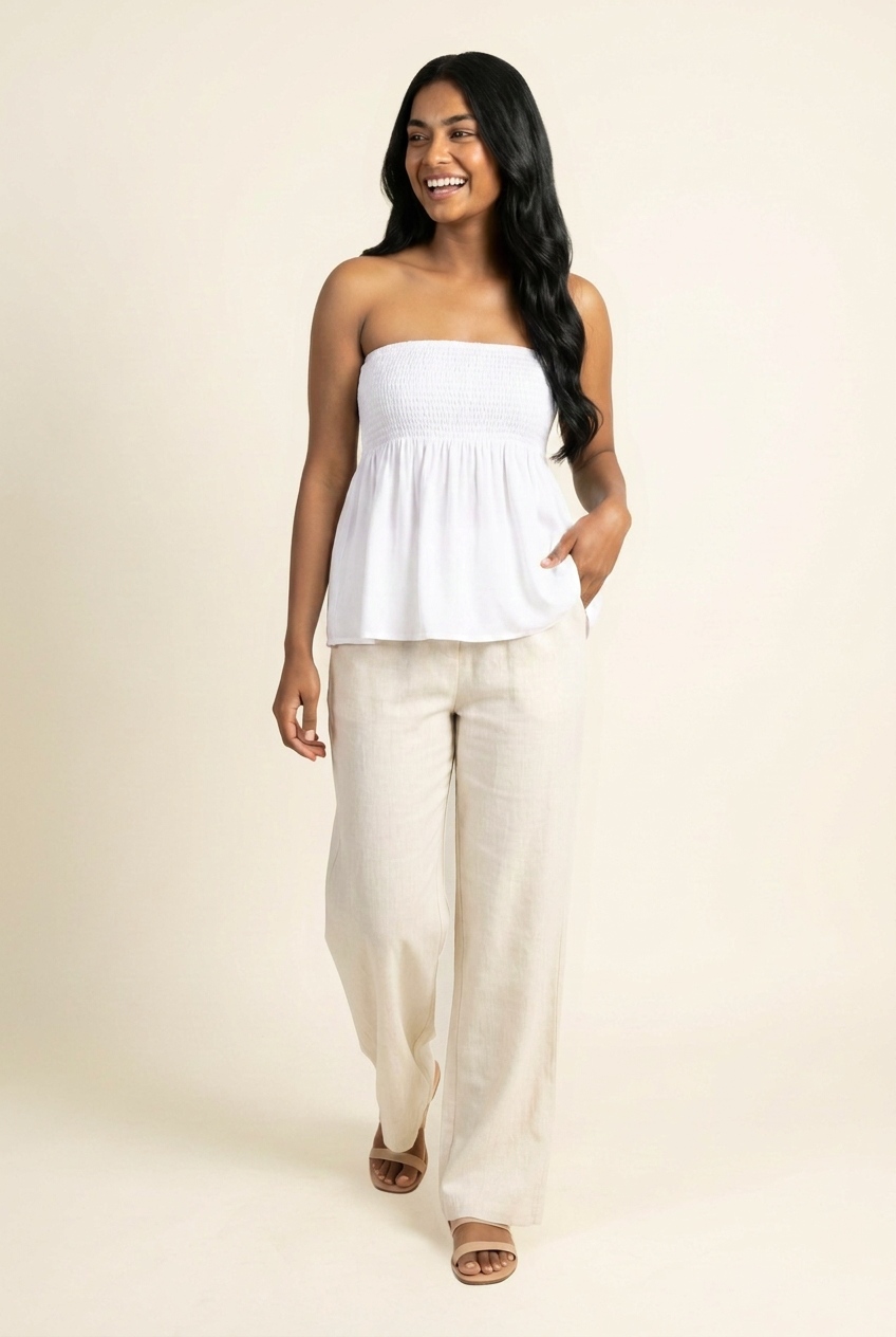 Kovelle shirred bandeau babydoll top in white, walking shot on model