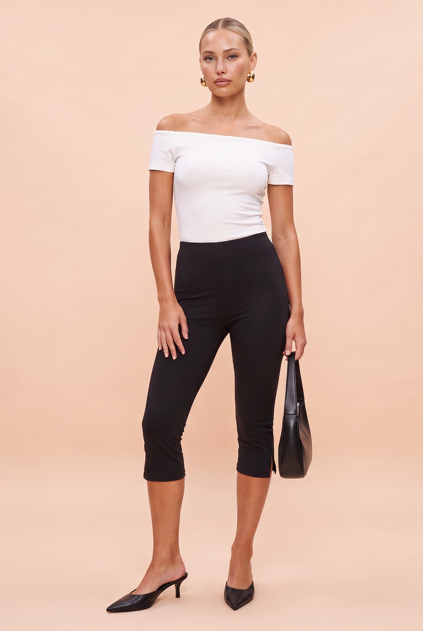 Kovelle split hem capri leggings in black, full length on model