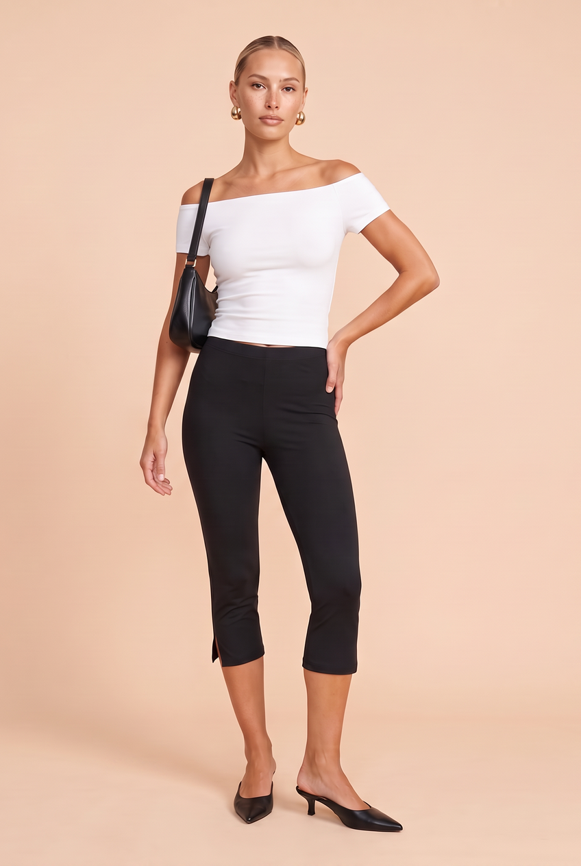 Kovelle split hem capri leggings in black, three-quarter view on model