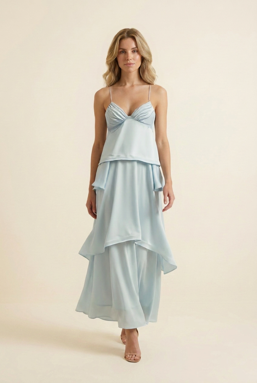 Kovelle tiered ruffle halter maxi dress in baby blue, walking shot with skirt tiers in motion, on model