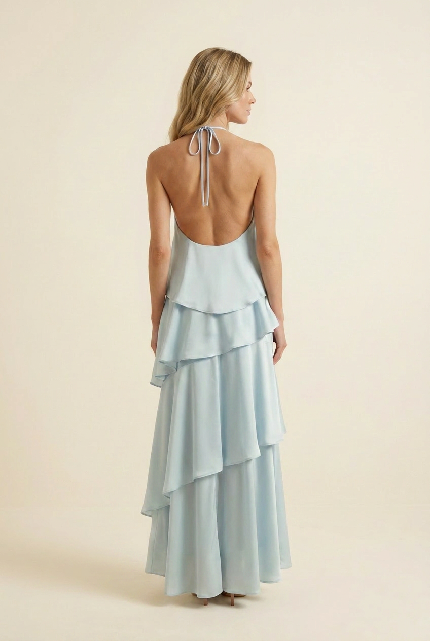 Kovelle tiered ruffle halter maxi dress in baby blue, back view with halter tie and low open back, on model