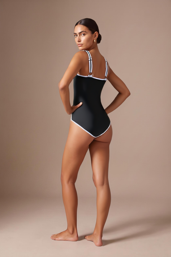 Back view of the Kovelle Black Scoop Swimsuit showing the adjustable white striped straps and continuous white piping