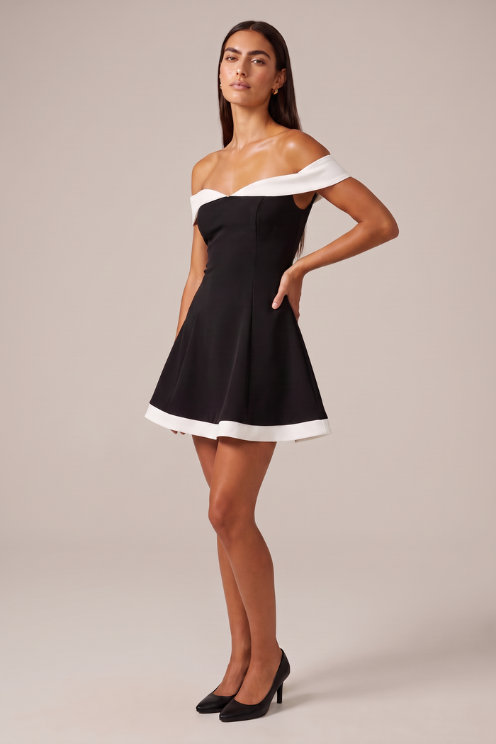 Three quarter view of the Kovelle Off Shoulder Contrast Flare Mini Dress showing the folded white off shoulder band