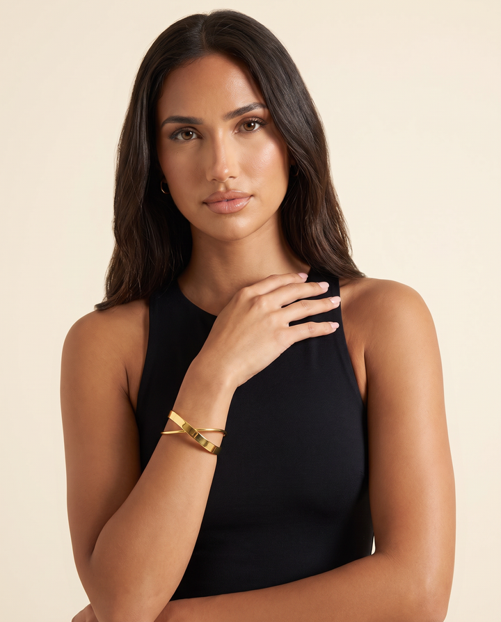 Model wearing the gold cross-line cuff on her wrist
