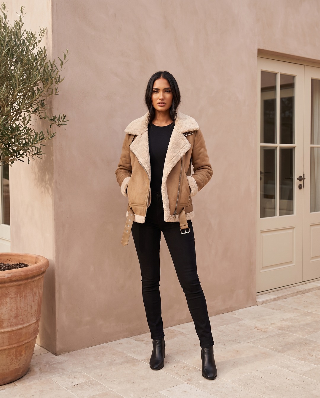 Kovelle tan faux suede borg aviator jacket, on model in the Kovelle House courtyard