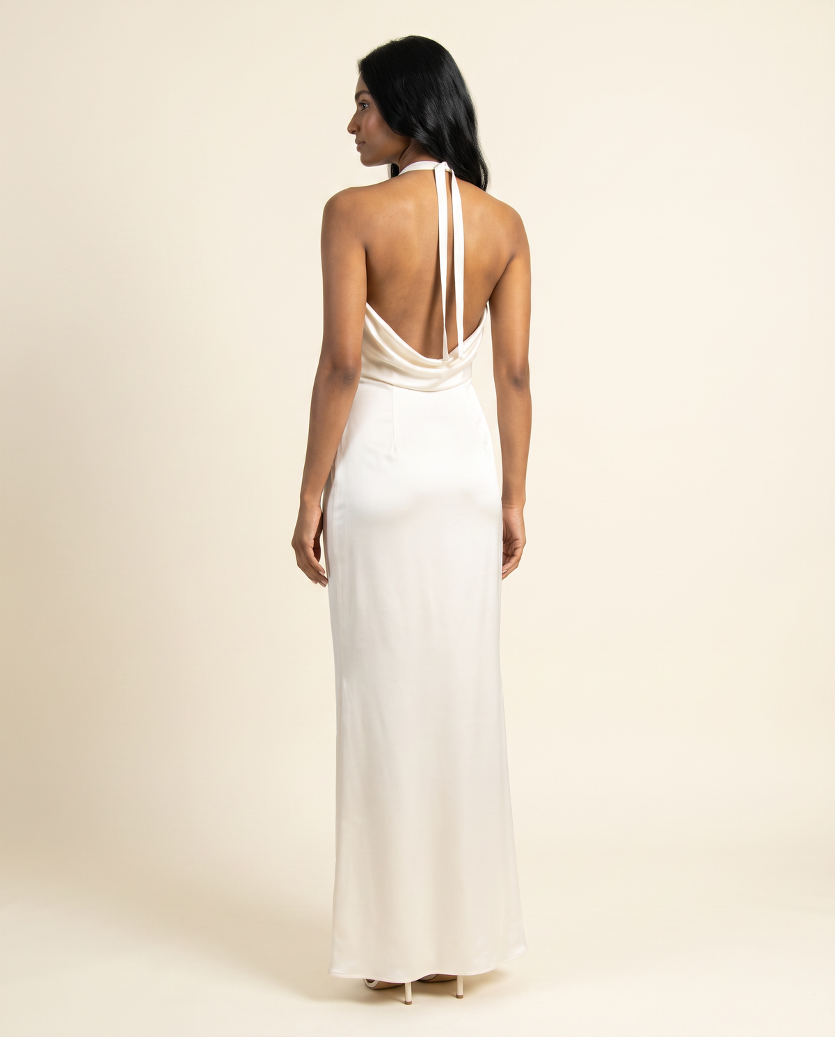 Kovelle ivory satin gown back view showing halter ties, on model