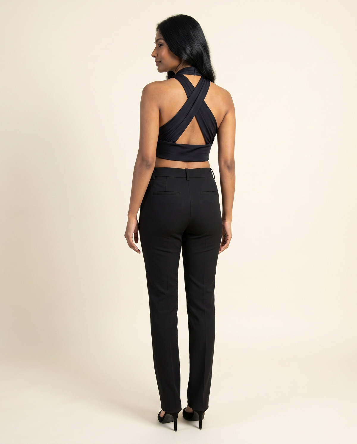 Kovelle black halter top back view showing straps, on model