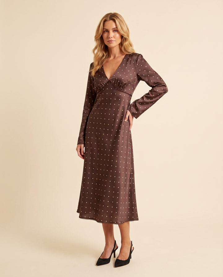 Kovelle chocolate dot midi dress three quarter view showing A-line skirt, on model